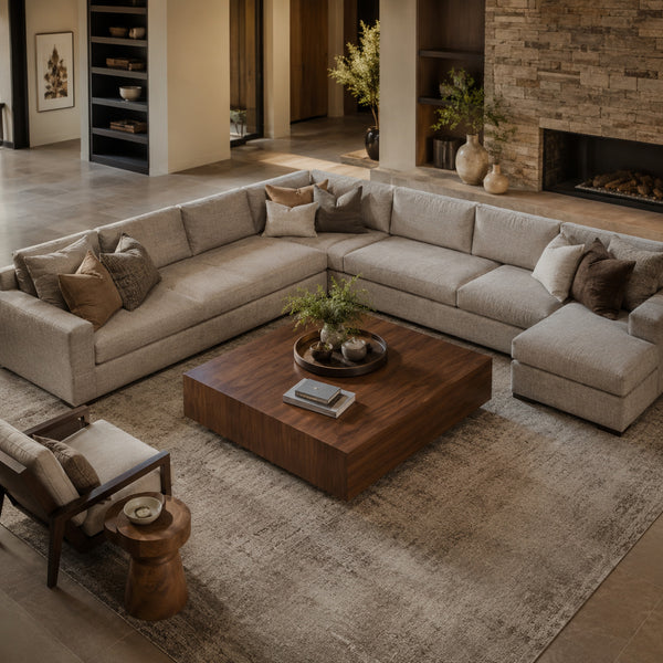 Large square coffee table centered within an L-shaped sectional sofa