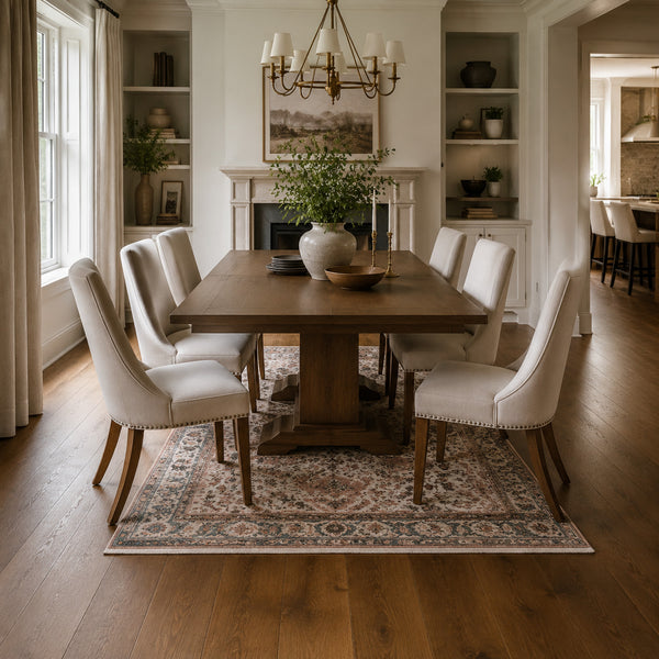 Undersized dining rug with chair legs on bare floor