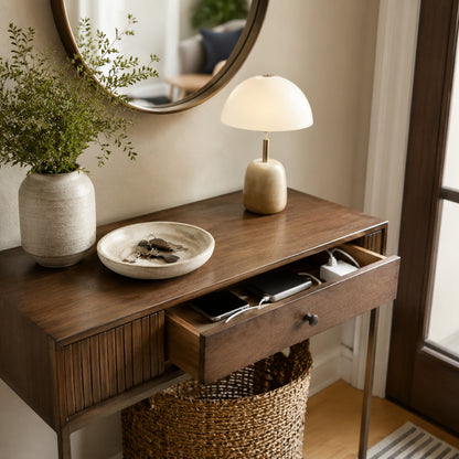 Entryway console styled with ceramic catch-all tray, table lamp and round mirror