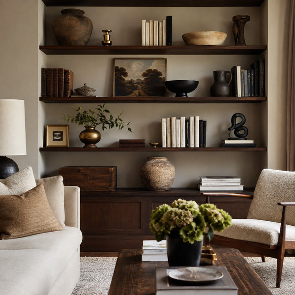 Vintage and modern decorative objects displayed on dark wood shelves