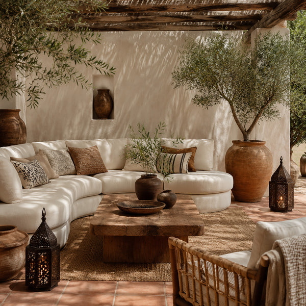 Evening outdoor living area with layered lighting and comfortable seating